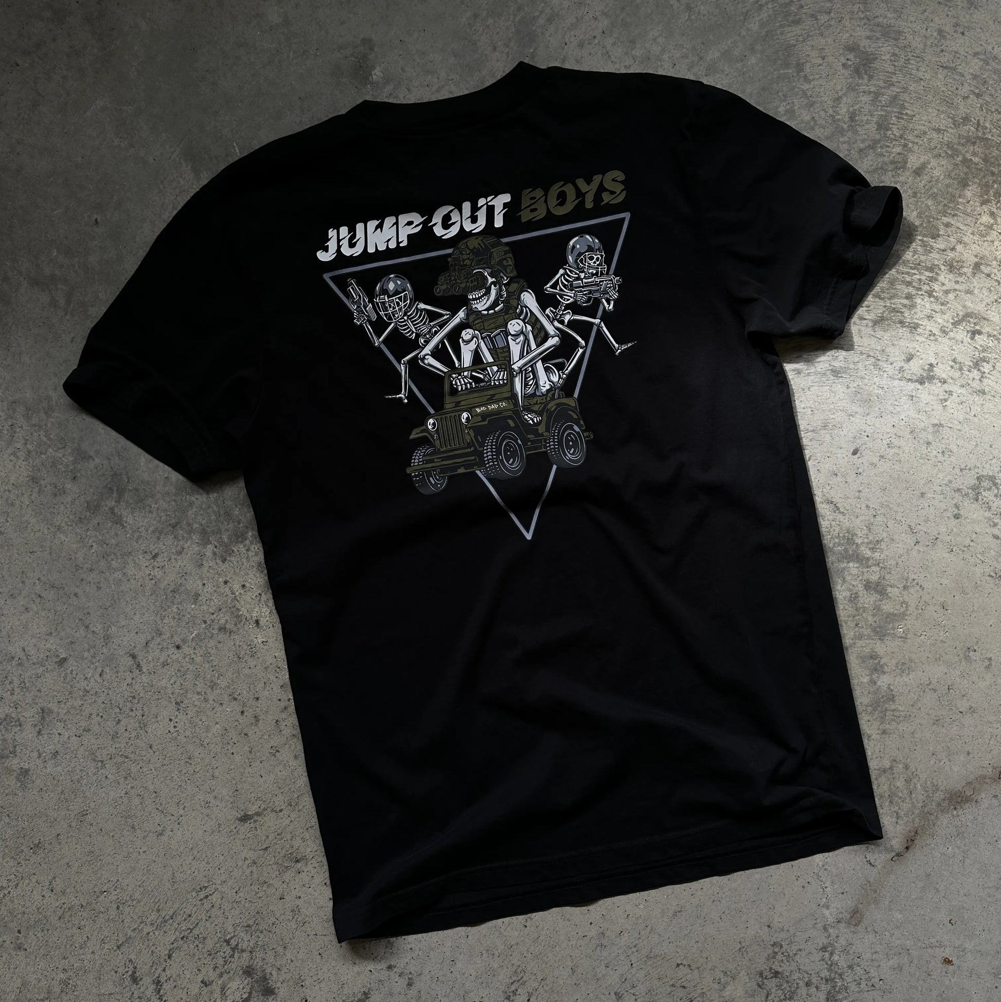 Jump Out Boys shirt laying flat on garage floor